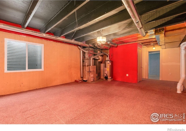 unfinished below grade area featuring heating unit, carpet floors, and gas water heater