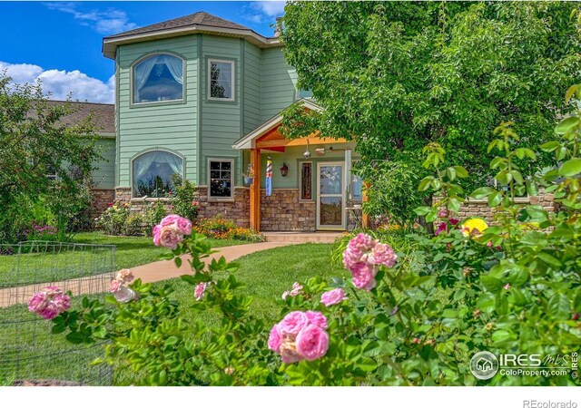 4514 Hoot Owl Dr, Berthoud, CO 80513 - view of front of house with stone siding and a front yard