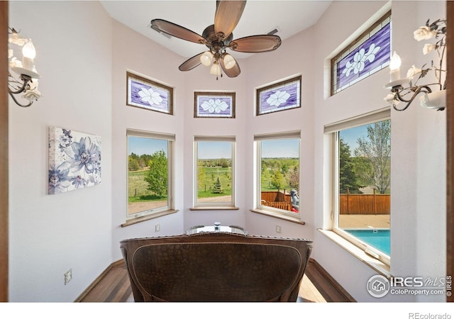 4514 Hoot Owl Dr, Berthoud, CO 80513 - living area with wood finished floors, a towering ceiling, baseboards, and ceiling fan