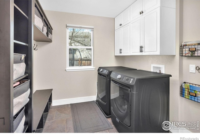 501 W Linden St, Louisville, CO 80027 - washroom featuring independent washer and dryer, cabinet space, stone tile floors, and baseboards