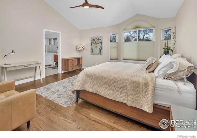 501 W Linden St, Louisville, CO 80027 - bedroom with a ceiling fan, connected bathroom, vaulted ceiling, and wood finished floors