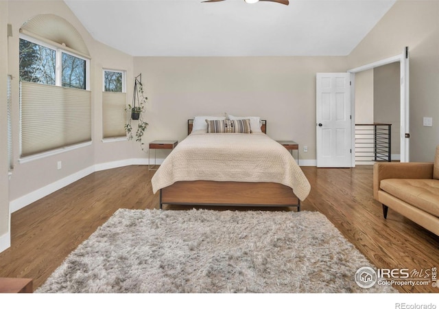 501 W Linden St, Louisville, CO 80027 - bedroom with baseboards, vaulted ceiling, wood finished floors, and a ceiling fan