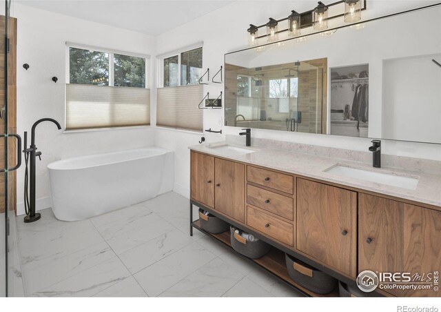 501 W Linden St, Louisville, CO 80027 - full bath with marble finish floor, a sink, double vanity, and a shower stall
