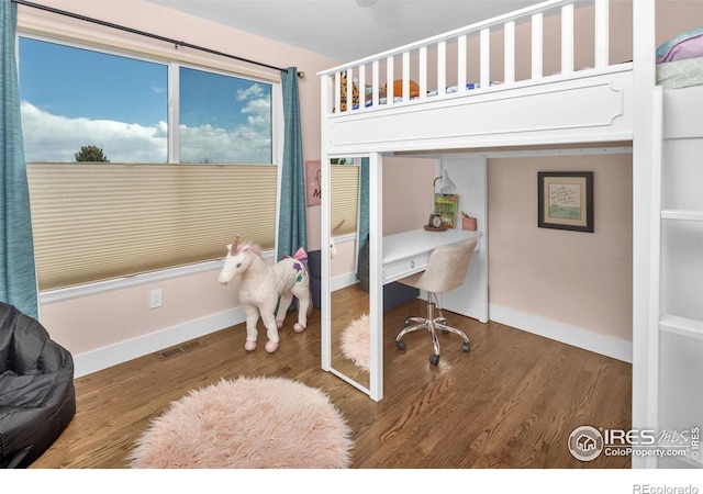 501 W Linden St, Louisville, CO 80027 - bedroom featuring baseboards, visible vents, a closet, and wood finished floors