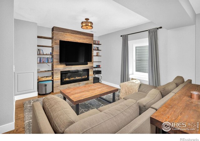 501 W Linden St, Louisville, CO 80027 - living area featuring baseboards, wood finished floors, and a large fireplace