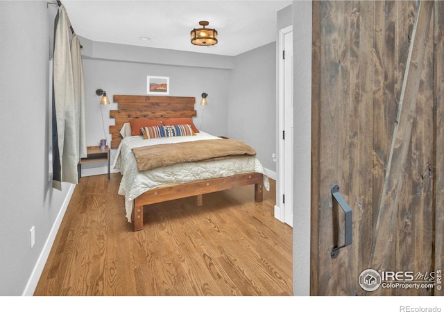 501 W Linden St, Louisville, CO 80027 - bedroom with baseboards and wood finished floors