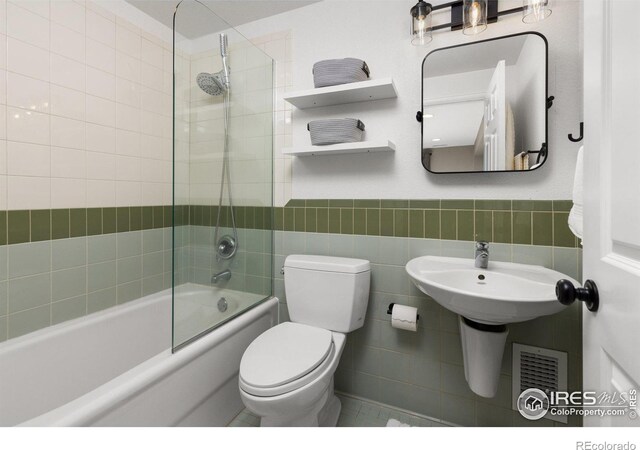501 W Linden St, Louisville, CO 80027 - bathroom featuring shower / bath combination, tile walls, toilet, visible vents, and wainscoting