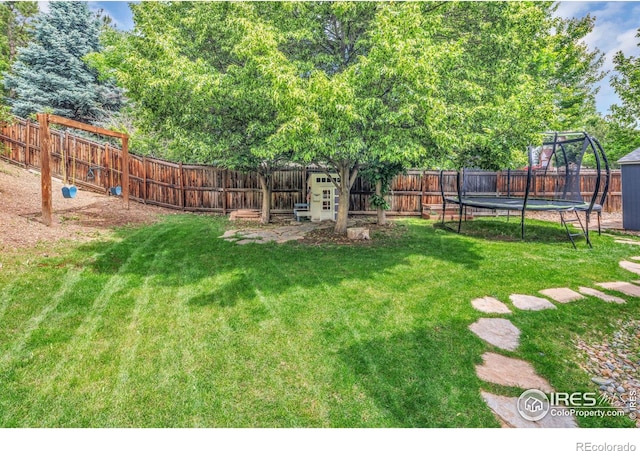 501 W Linden St, Louisville, CO 80027 - view of yard featuring a fenced backyard, a playground, and a trampoline