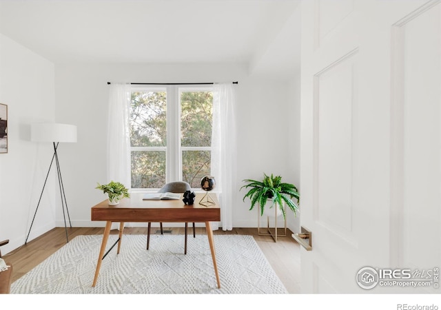 office with wood finished floors and baseboards