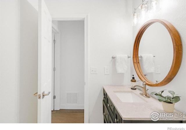 bathroom with vanity, wood finished floors, and visible vents
