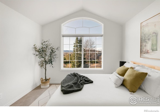 bedroom featuring lofted ceiling, carpet flooring, and baseboards