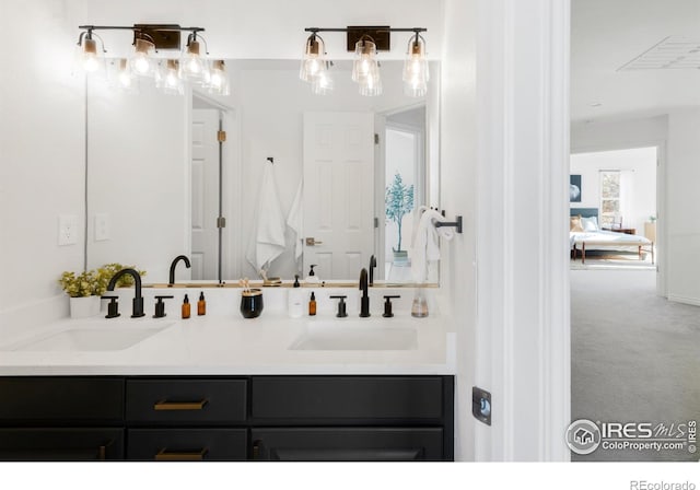 full bathroom featuring double vanity and a sink