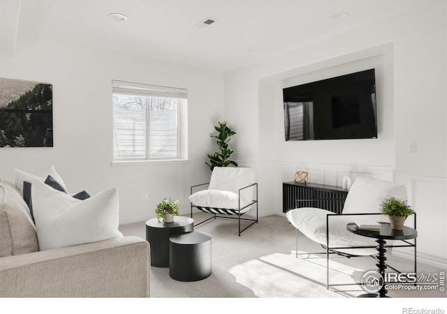 carpeted living room with visible vents