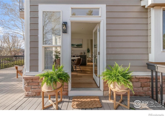 view of exterior entry featuring a deck