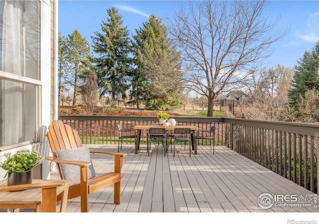 wooden deck featuring outdoor dining area