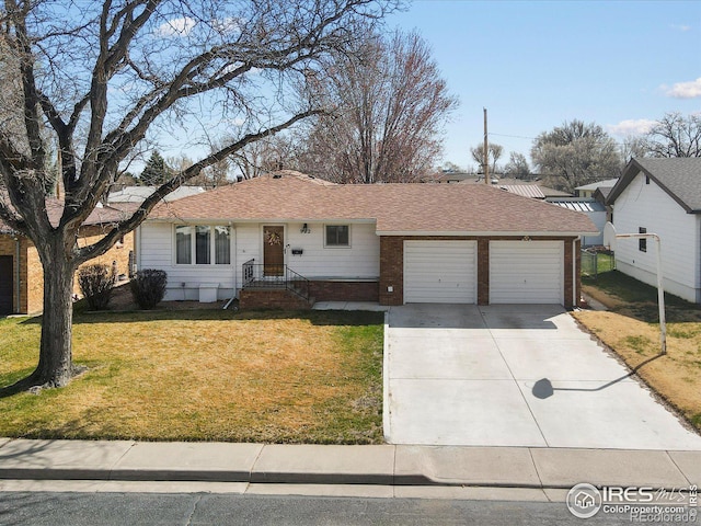 ranch-style home with concrete driveway, roof with shingles, a front yard, brick siding, and a garage