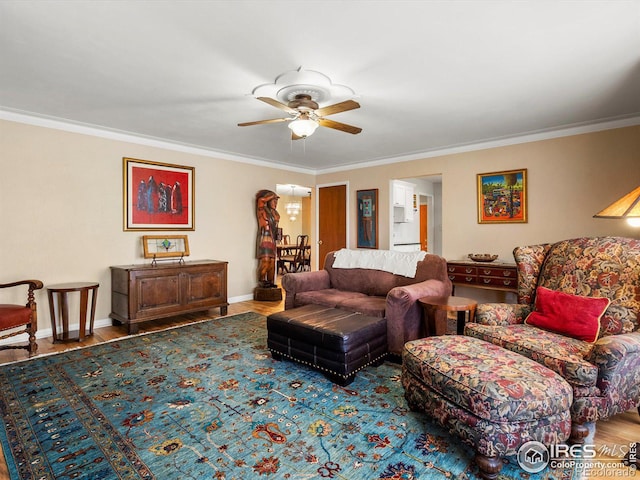 living room with baseboards, ornamental molding, wood finished floors, and a ceiling fan