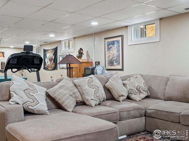 living area featuring a paneled ceiling