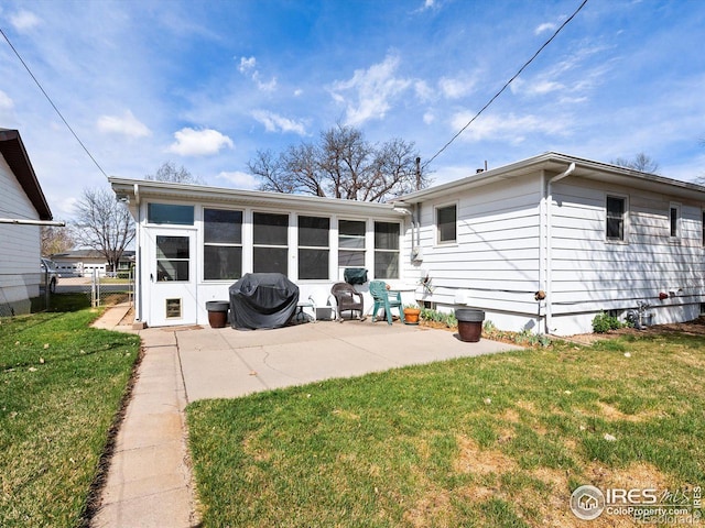 back of property featuring a sunroom, fence, a yard, and a patio