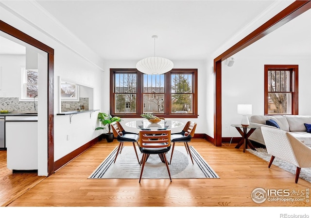 dining area featuring baseboards and light wood-style floors
