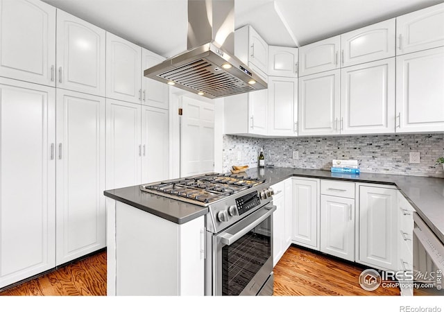 kitchen featuring white cabinetry, light wood-style flooring, stainless steel appliances, and wall chimney exhaust hood