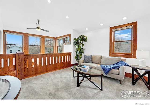 carpeted living area with recessed lighting and a ceiling fan
