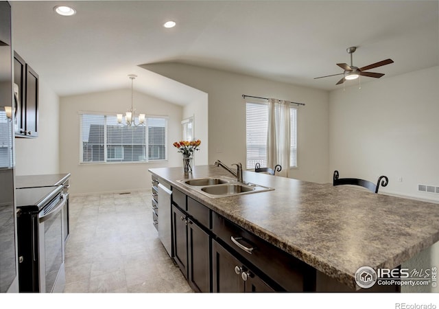 kitchen featuring a sink, ceiling fan with notable chandelier, an island with sink, appliances with stainless steel finishes, and visible vents