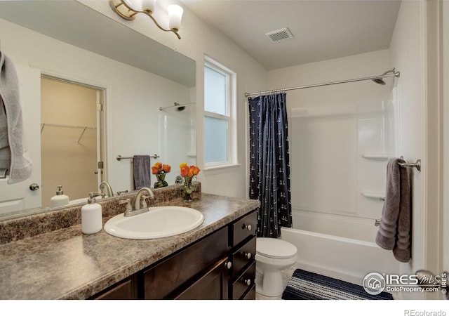 bathroom with shower / tub combo, toilet, vanity, and visible vents