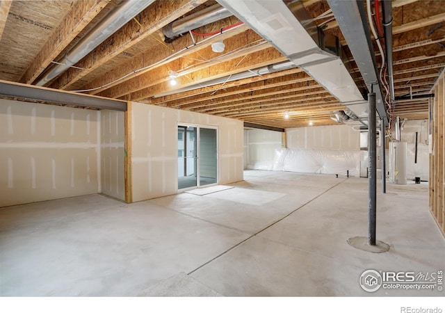 unfinished basement featuring water heater