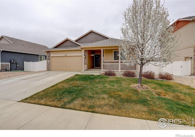view of front facade with driveway, a porch, a front lawn, and fence