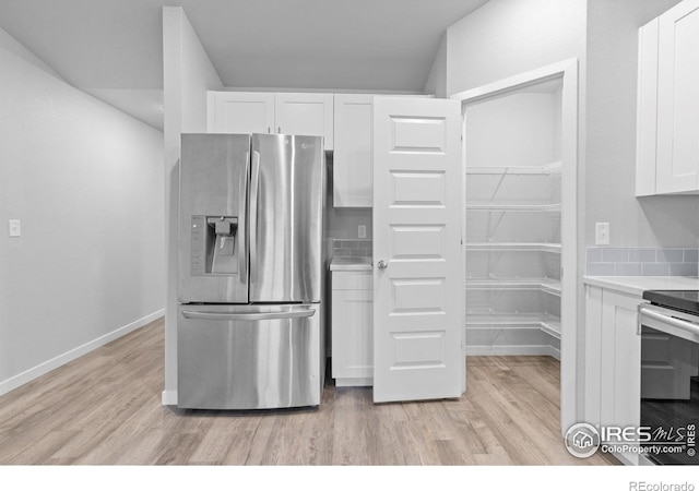 702 S Fulton Ave, Fort Lupton, CO 80621 - kitchen with stainless steel appliances, white cabinetry, light wood-type flooring, and light countertops
