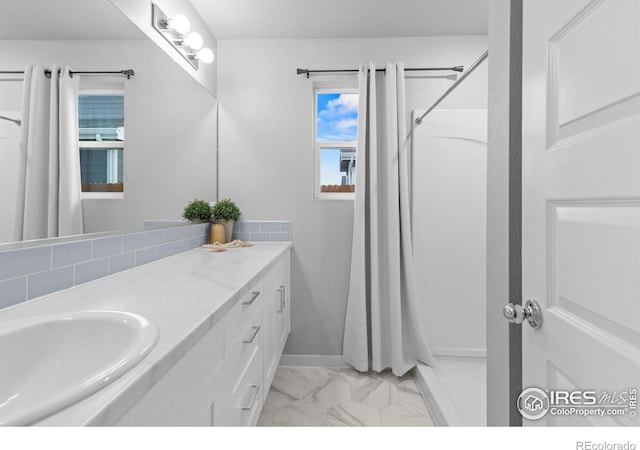 702 S Fulton Ave, Fort Lupton, CO 80621 - bathroom with vanity, marble look tile flooring, and curtained shower