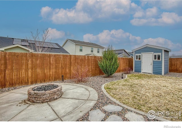 702 S Fulton Ave, Fort Lupton, CO 80621 - fenced backyard with an outdoor fire pit, a storage unit, and a patio