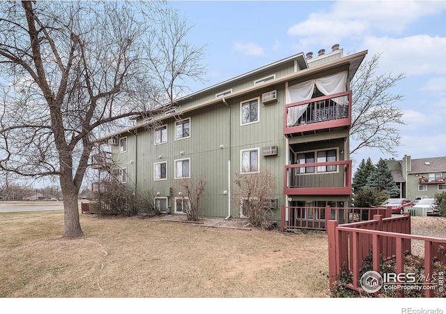 4501 E Boardwalk Dr Unit A9, Fort Collins, CO 80525 - back of property featuring a chimney, a yard, and a balcony