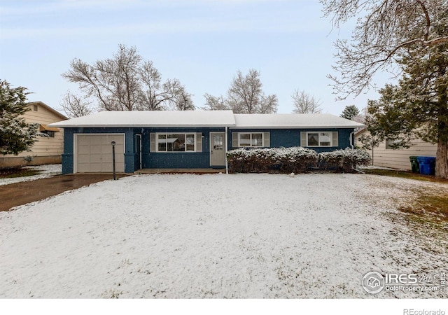 single story home with driveway and an attached garage