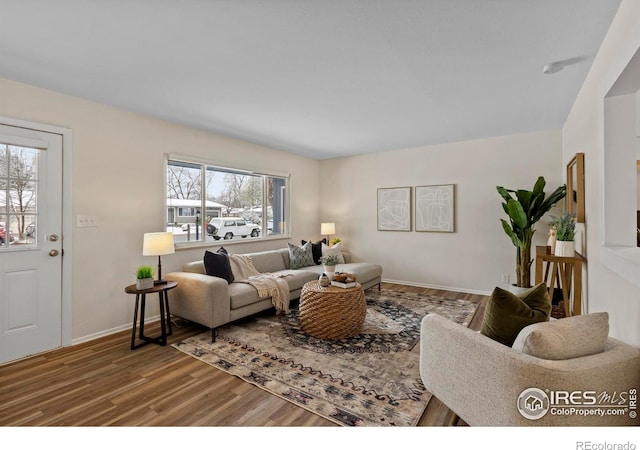 living room featuring baseboards and wood finished floors