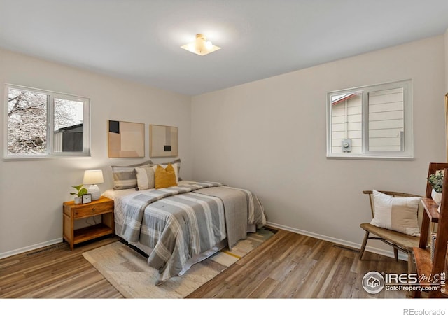 bedroom with baseboards and light wood-type flooring
