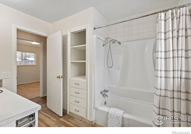 bathroom with shower / bath combination with curtain, vanity, and wood finished floors
