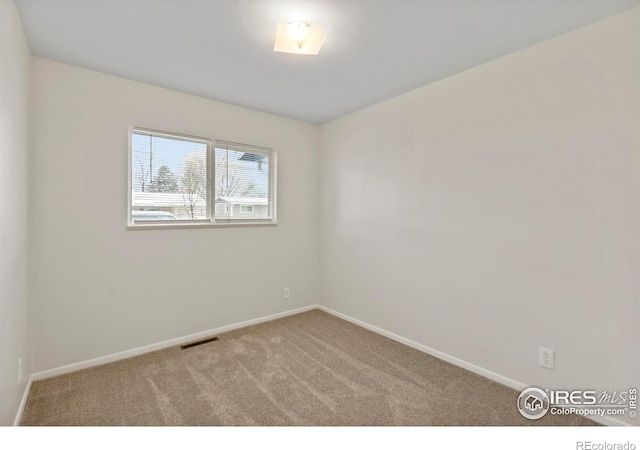 carpeted empty room with baseboards and visible vents