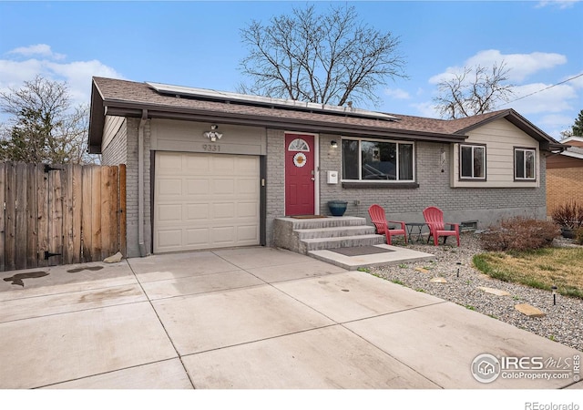 9331 Irving St, Westminster, CO 80031 - single story home featuring solar panels, brick siding, concrete driveway, and an attached garage