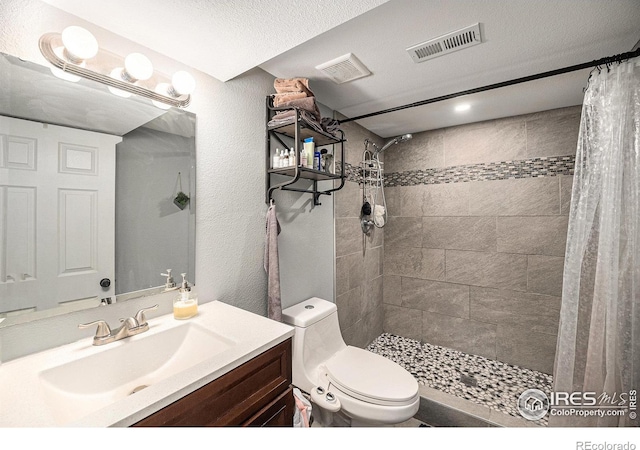 9331 Irving St, Westminster, CO 80031 - bathroom with toilet, visible vents, tiled shower, and vanity