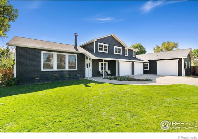 2017 Harmony Dr, Fort Collins, CO 80525 - view of front facade with fence, an attached garage, concrete driveway, a front yard, and brick siding