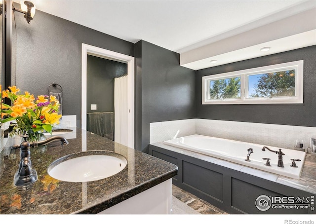 2017 Harmony Dr, Fort Collins, CO 80525 - bathroom with double vanity, a sink, a shower with shower curtain, and a bath