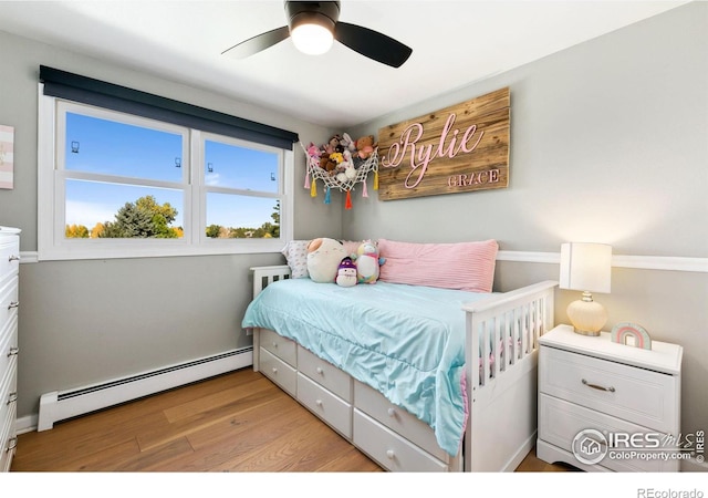 2017 Harmony Dr, Fort Collins, CO 80525 - bedroom with light wood-type flooring, ceiling fan, and baseboard heating