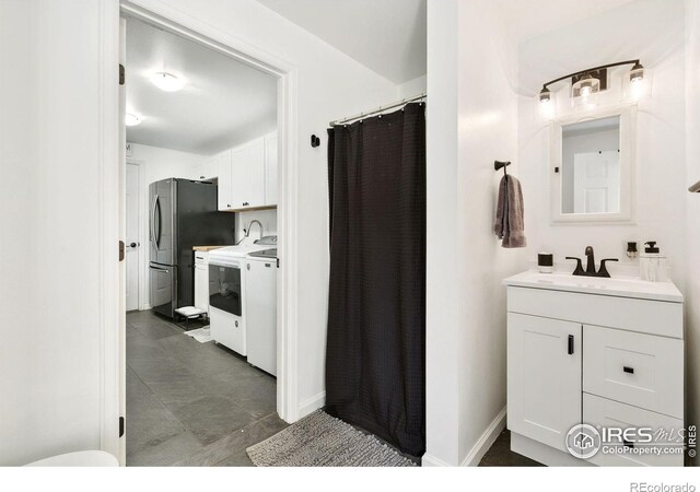 2017 Harmony Dr, Fort Collins, CO 80525 - full bathroom with a shower with curtain, vanity, and baseboards