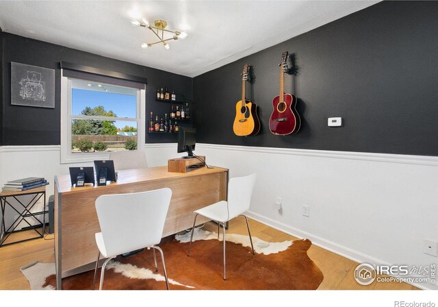 2017 Harmony Dr, Fort Collins, CO 80525 - office featuring a notable chandelier, wood finished floors, and a dry bar