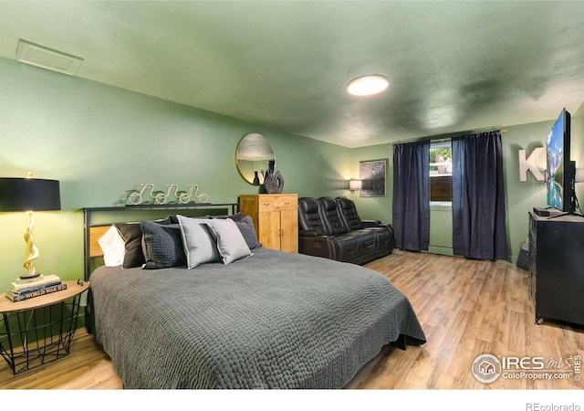 2017 Harmony Dr, Fort Collins, CO 80525 - bedroom with visible vents, wood finished floors, and attic access