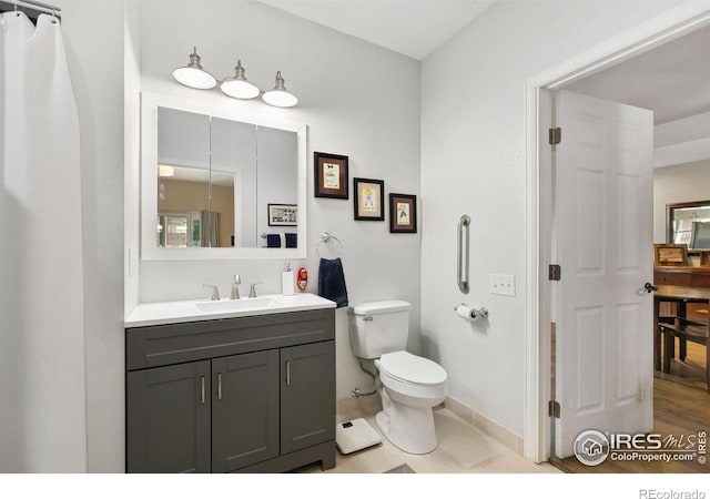 2017 Harmony Dr, Fort Collins, CO 80525 - bathroom featuring baseboards, toilet, and vanity