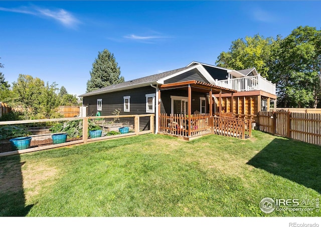 2017 Harmony Dr, Fort Collins, CO 80525 - back of house featuring a lawn, a fenced backyard, a patio, and a vegetable garden
