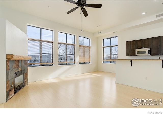 1200 Yarmouth Ave Unit 239, Boulder, CO 80304 - unfurnished living room with a fireplace, ceiling fan, light wood-style floors, recessed lighting, and baseboards